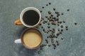 Two cups of coffee. Two flavors on black background.