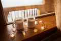 Two cups of coffee on the windowsill in a wooden house in the Carpathians Royalty Free Stock Photo