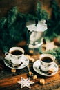 Two cups of espresso with pieces of cane sugar and Italian coffee maker on wooden table. Royalty Free Stock Photo