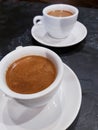 Two cups of fragrant and strong black coffee on the black and stylish table in the cafe. Lifestyle and leisure concept. Royalty Free Stock Photo