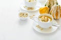 Two cups with fresh pumpkin cream soup decorated cream, seeds and crackers Royalty Free Stock Photo