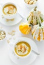 Two cups with fresh pumpkin cream soup decorated cream, seeds and crackers Royalty Free Stock Photo