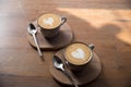 Two Cups of hot cappuccino on wooden table background Royalty Free Stock Photo