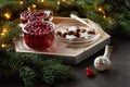 Two cups with hot Christmas spicy drink with cranberry and cakes