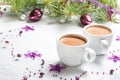 Two cups of hot cocoa and Christmas decorations on old wooden shabby background Royalty Free Stock Photo