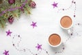 Two cups of hot cocoa and Christmas decorations on white wooden table. Flat lay Royalty Free Stock Photo