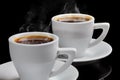 Two cups of hot coffee with steam on a black background Royalty Free Stock Photo