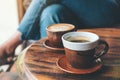 Two cups of hot latte coffee and black coffee on vintage wooden table in cafe Royalty Free Stock Photo