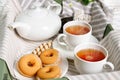 Two cups of hot tea with delicious cookies on white wooden table Royalty Free Stock Photo