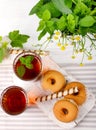 Two cups of hot tea with delicious cookies on white wooden table Royalty Free Stock Photo