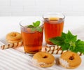 Two cups of hot tea with delicious cookies on white wooden table Royalty Free Stock Photo