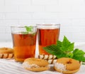 Two cups of hot tea with delicious cookies on white wooden table Royalty Free Stock Photo