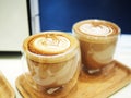 Two Cups of Latte with Latte Art in a Double Insulated Glass