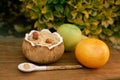 Two cups of lemonade with citrus lobules of lemons, oranges, grapefruits and coconut with oat meal