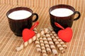 Two cups with milk, thin hearts Royalty Free Stock Photo