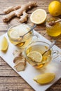 Two cups of natural herbal tea ginger lemon and honey on a wooden background Royalty Free Stock Photo