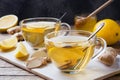 Two cups of natural herbal tea ginger lemon and honey on a wooden background Royalty Free Stock Photo