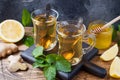 Two cups of natural herbal tea ginger lemon mint and honey on a wooden background Royalty Free Stock Photo