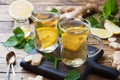 Two cups of natural herbal tea ginger lemon mint and honey on a wooden background Royalty Free Stock Photo