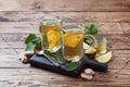 Two cups of natural herbal tea ginger lemon mint and honey on a wooden background. Copy space Royalty Free Stock Photo