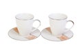 Two cups for tea or coffee on saucers, isolated on white background. Royalty Free Stock Photo