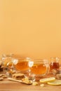 Two cups of tea with lemon, honey, ginger root ingredients and ginger biscuits on wooden table. Natural medicine concept Royalty Free Stock Photo