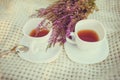 Two cups of tea on a plaid with bouquet of heather Royalty Free Stock Photo