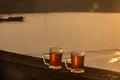 Two Cups of tea at sunrise or sunset over mountain and lake background. Royalty Free Stock Photo