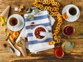 Two cups of tea, various jams and other sweets on the old wooden table. Dry grass Royalty Free Stock Photo