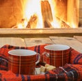 Relax with cup of tea before cozy fireplace. Royalty Free Stock Photo