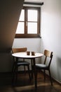 Two cups on wooden table. Dining room with table and two chairs. Modern minimal Scandinavian nordic interior. Morning coffee Royalty Free Stock Photo