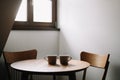 Two cups on wooden table. Dining room with table and two chairs. Modern minimal Scandinavian nordic interior. Morning coffee Royalty Free Stock Photo