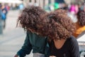 Two Curly haird girls in the square of Milan