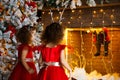 Two curly little girls looking at the christmas fireplace near b Royalty Free Stock Photo