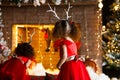 Two curly little girls looking at the christmas fireplace near b Royalty Free Stock Photo