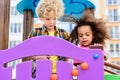 two curly multiethnic little kids having fun