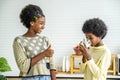 Two cute adorable siblings african american children having breakfast with milk at kitchen, Portrait of happy brother drinking Royalty Free Stock Photo