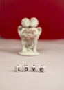 Two cute angels and the word love are made of ivory .Valentine`s Day. Postcard for the holidays Royalty Free Stock Photo