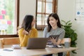 Two cute asian businesswoman sitting at table discussing financial accounting Royalty Free Stock Photo