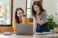 Two cute asian businesswoman sitting at table discussing financial accounting Royalty Free Stock Photo