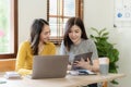 Two cute asian businesswoman sitting at table discussing financial accounting Royalty Free Stock Photo