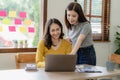 Two cute asian businesswoman sitting at table discussing financial accounting Royalty Free Stock Photo