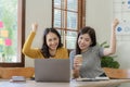 Two cute asian businesswoman sitting at table discussing financial accounting Royalty Free Stock Photo