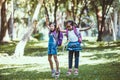 Two cute asian child girl having fun to play and jump together