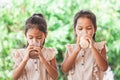 Two cute asian child girls drinking a milk from glass together Royalty Free Stock Photo