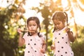 Two cute asian child girls having fun to play with bubbles Royalty Free Stock Photo