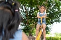 Two cute asian child girls playing seesaw together in the playground