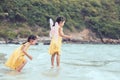 Two cute asian little child girls play and jump on beach Royalty Free Stock Photo