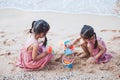 Two cute asian little child girls having fun to play with sand Royalty Free Stock Photo