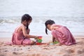 Two cute asian little child girls having fun to play with sand Royalty Free Stock Photo